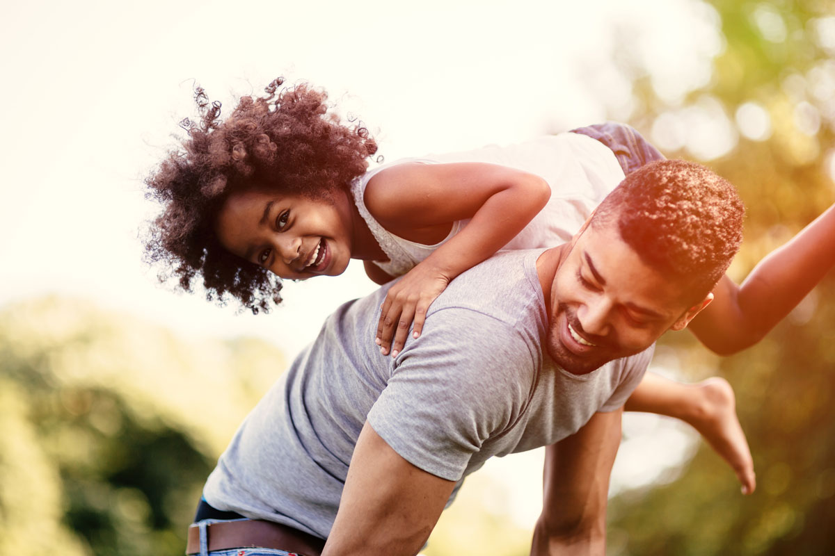 Father carrying daughter piggyback