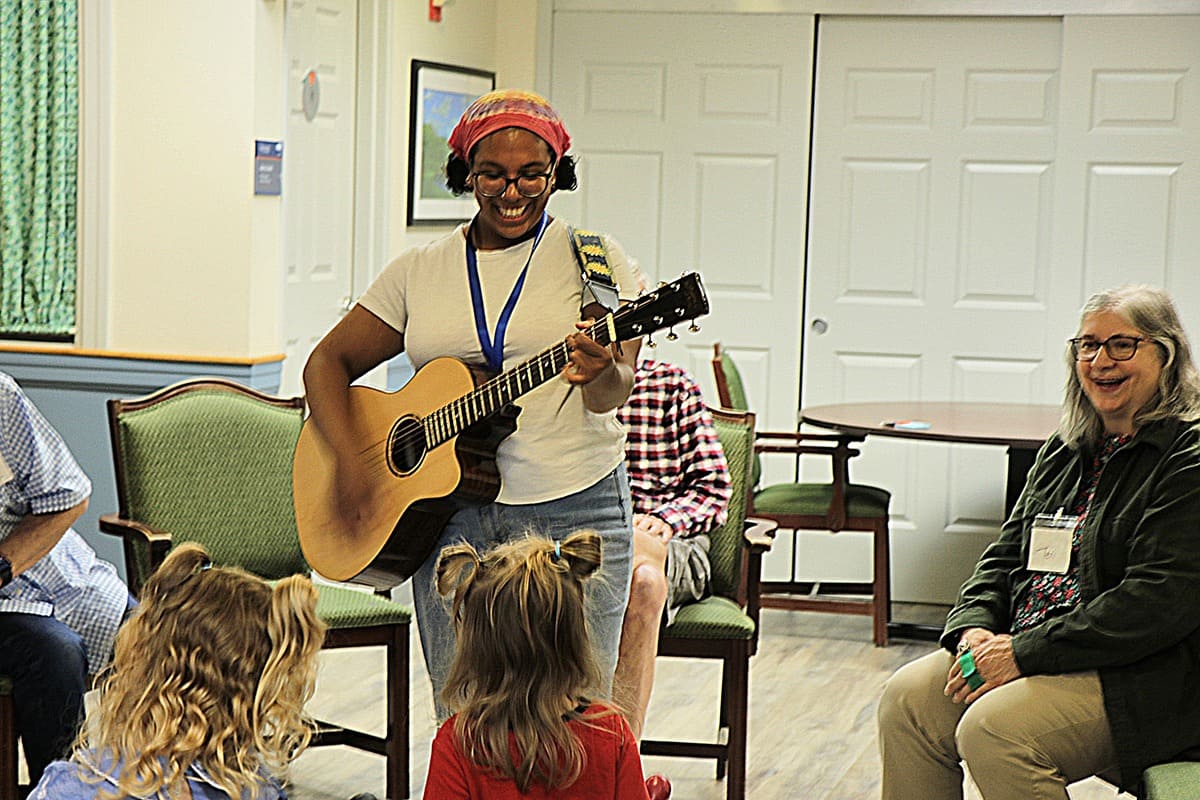 Manchester Community Music School member playing guitar