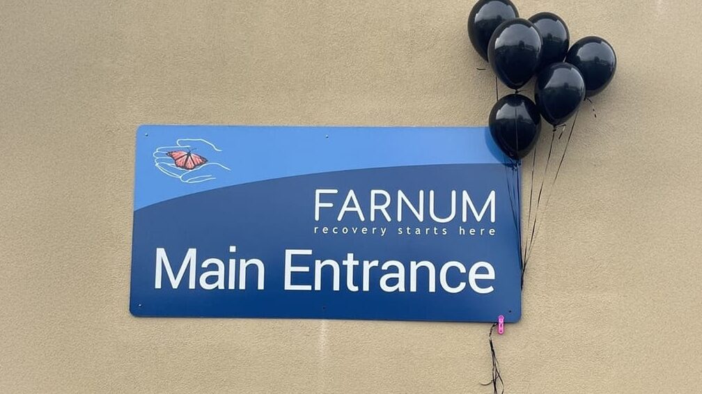 Farnum center main entrance sign with black balloons.