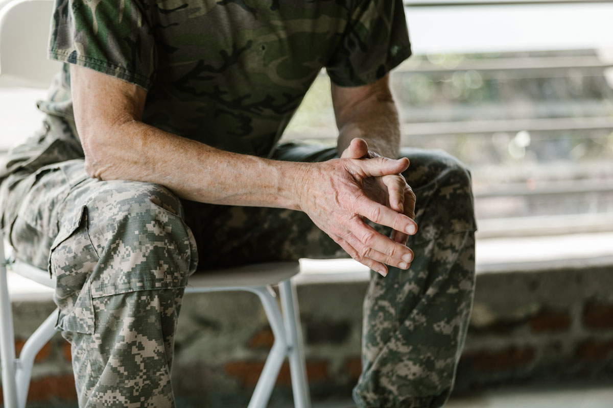 Photo of a United States Army Veteran sitting on a bench.