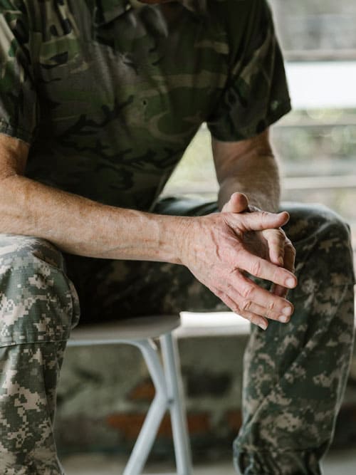 Photo of United States Army Veteran sitting on a bench.