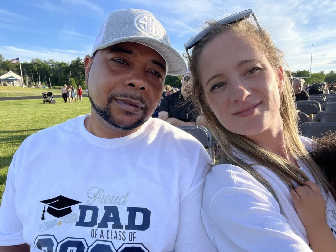 Shawn and Amy at an outdoor high school graduation ceremony 