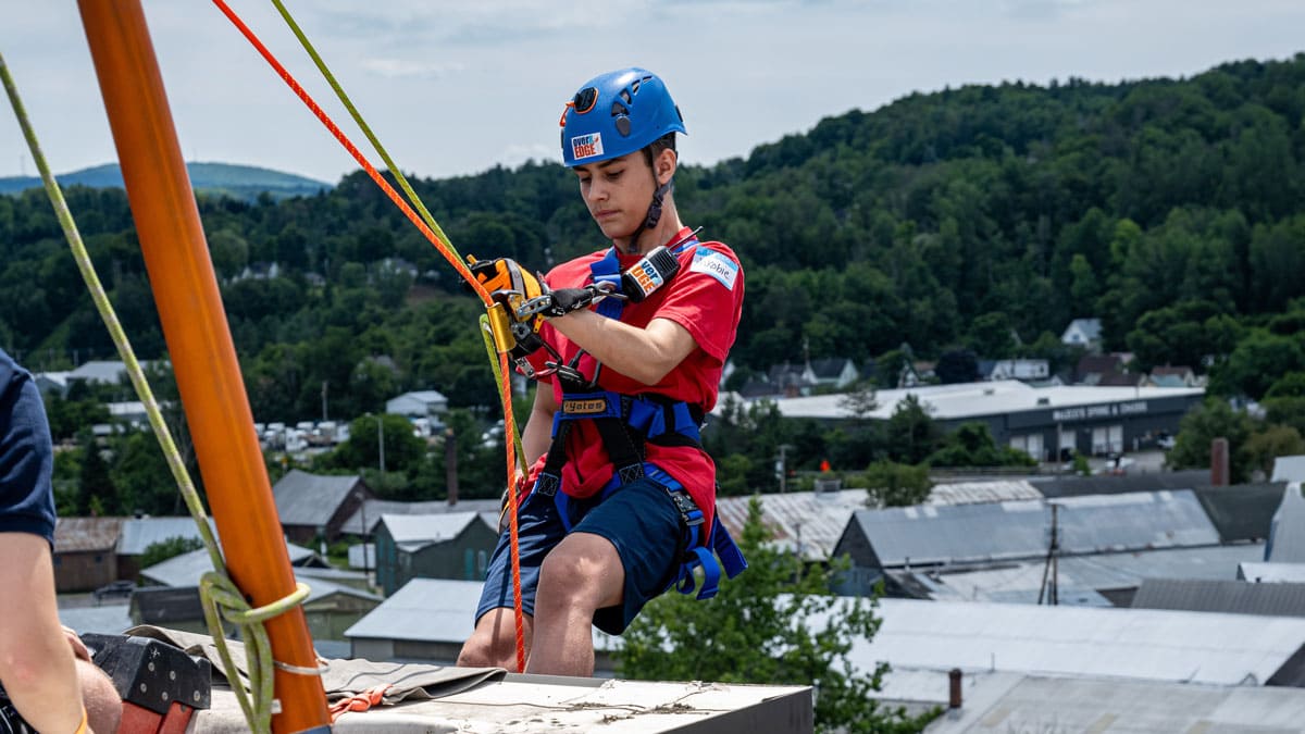 Jakobie, a youth who utilizes Easterseals VT's Post Permanency Services, prepares to go over the edge of the 11-story North Barre Manor building in Barre, VT.