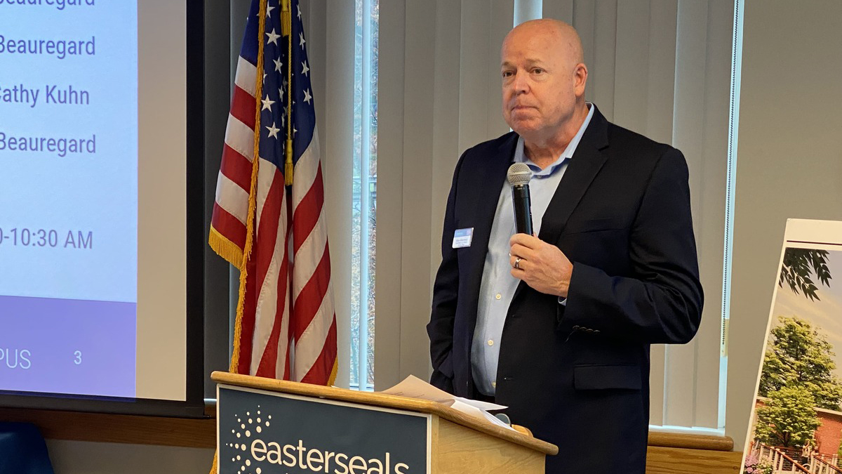 Allen Aldenberg speaking at podium